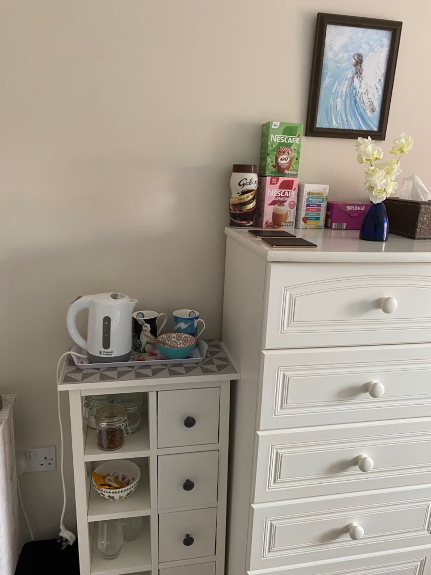 Tea and coffee tray with kettle, mugs and a selection of hot drinks