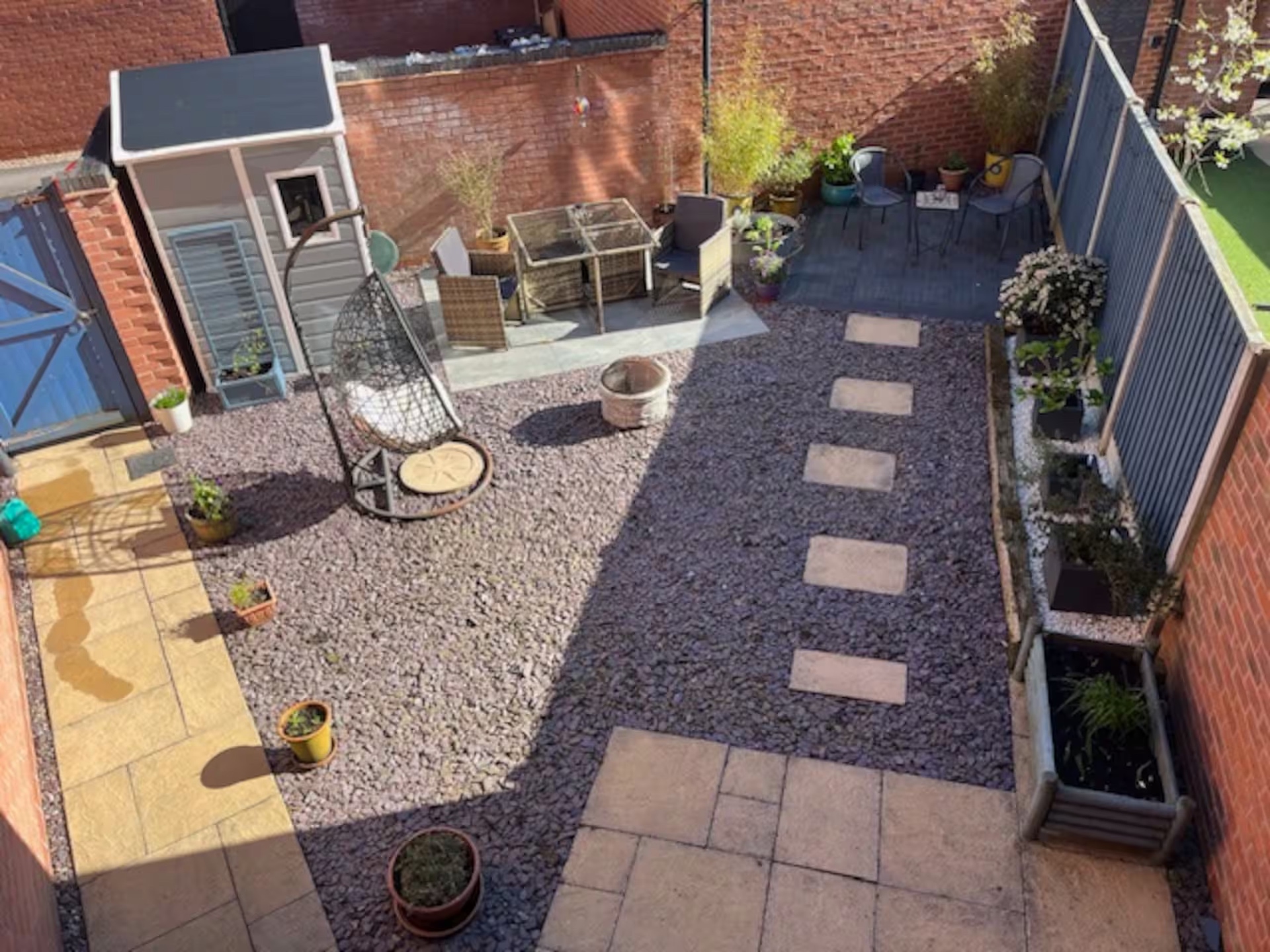 The rear garden at Riverside B&B — gravel, stepping stones and seating areas